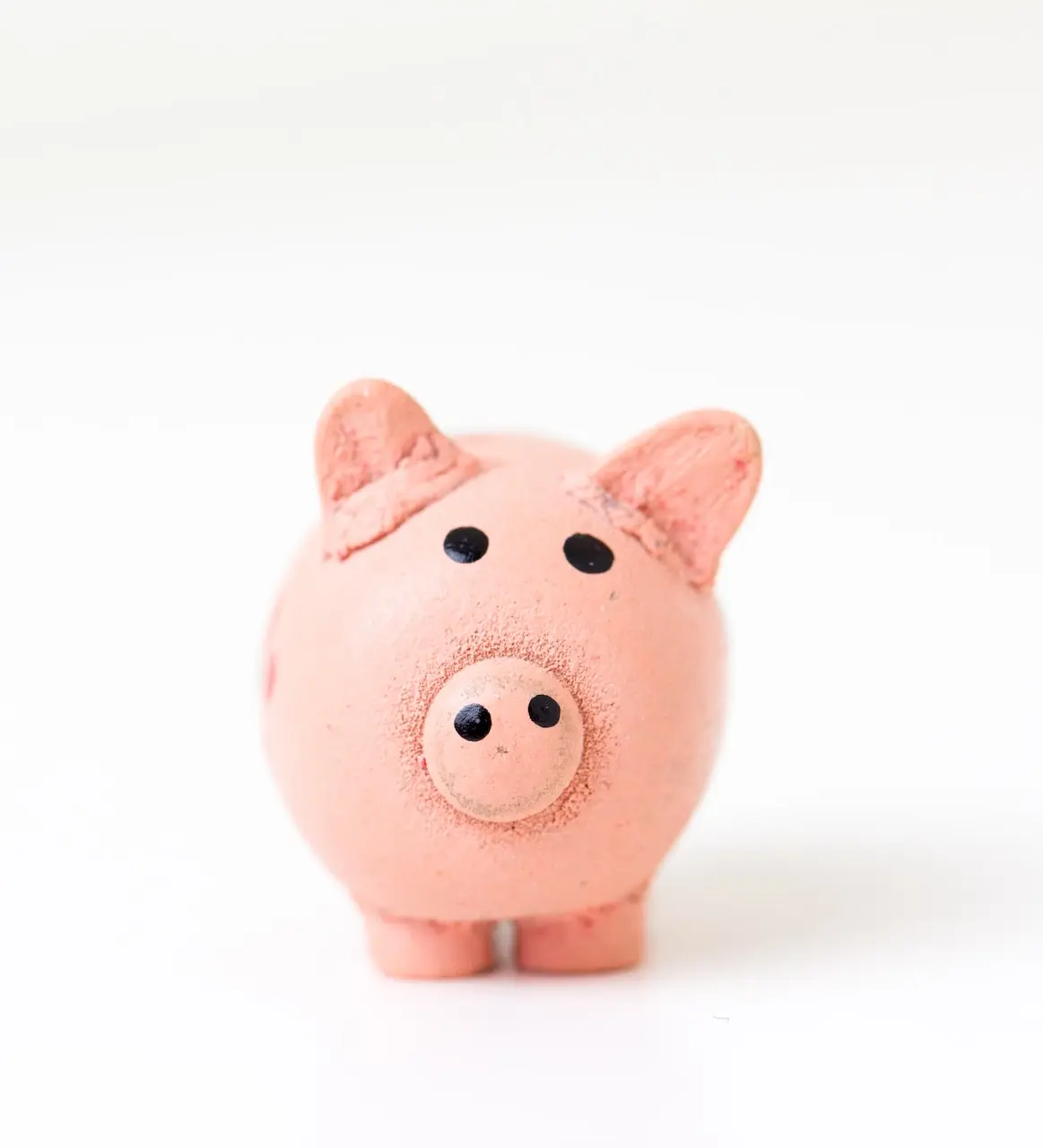 pink pig figurine on white surface